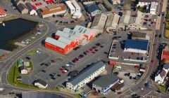 The shopping centre and its car park seen in the middle of the photo.