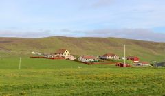 The housing would start at the north side of houses at Upper Scalloway, pictured here. Photo: Shetland News