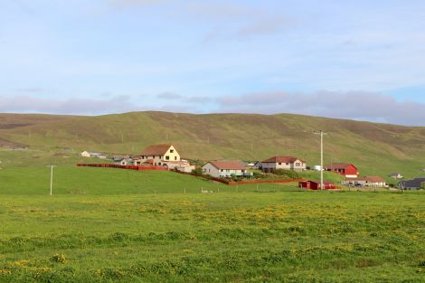 The housing would start at the north side of houses at Upper Scalloway, pictured here. Photo: Shetland News
