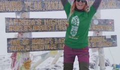 Anita Georgeson unfurling the Shetland flag at top of Africa.