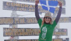 Anita Georgeson unfurling the Shetland flag at top of Africa.