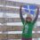 Anita Georgeson unfurling the Shetland flag at top of Africa.