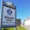 A sign outside a stone building reads "Police Scotland, Police Lerwick, Shetland Area Office" on a clear day with a blue sky.