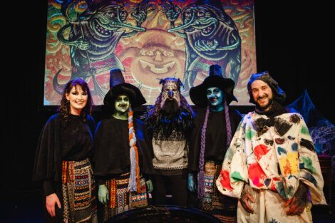A group of people dressed as witches posing for a photo.