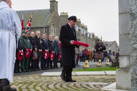 A group of people standing in front of a memorial.