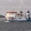 A large ferry named "NorthLink" sails in open water, with a lighthouse visible in the background. © Austin Taylor Photography, 2023.