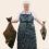 A person wearing a striped apron and a hairnet holds a large fish in each hand, standing against a plain background.