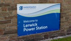 Sign reading "Welcome to Lerwick Power Station" with the logo of Scottish & Southern Electricity Networks against a brick wall background.