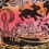 A colorful illustration featuring a boat labeled "LK 272" on rough waters, surrounded by abstract swirls, flowers, and marine-themed patterns. The background transitions from red to orange hues.