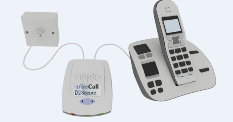 A cordless telephone set connected to a trueCall Secure device, featuring a wall-mounted socket, main unit, and handset with a digital display.