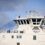 The bridge of a ferry named 'daggalien' with the destination 'lerwick' displayed, against a backdrop of a cloudy sky.