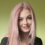 A woman with pink hair posing for a photo.
