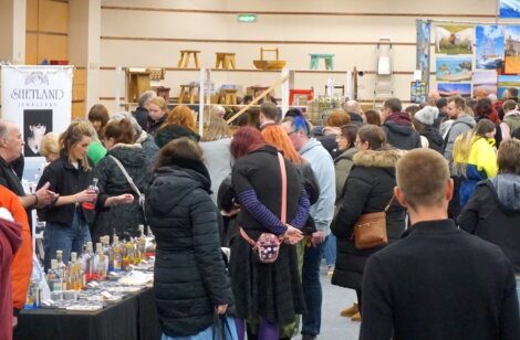 A crowd of people standing in a large room.