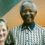Nelson mandela and a woman posing for a photo.