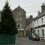 A street in scotland with a tree in the middle.