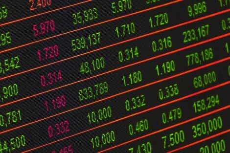 A close up of a stock board with many numbers on it.