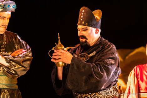 Three men dressed in asian costumes standing next to each other.