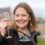 A woman holding a wine glass.