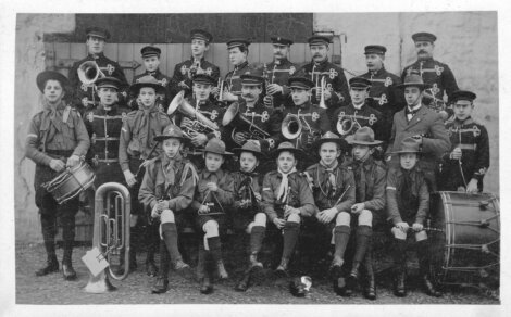 A group of men in uniform posing for a photo.