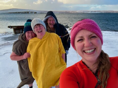 A group of people taking a selfie in the snow.
