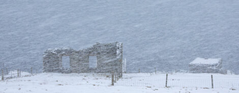 Ruins of an old house in the snow.