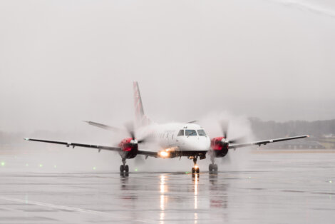 A small plane on a wet runway.