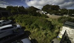 An aerial view of a parking lot with cars parked in it.