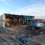 A building is being demolished by a bulldozer.