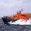 An orange boat in the water.