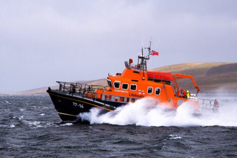 An orange boat in the water.