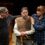Two actors comforting a distressed colleague on stage.