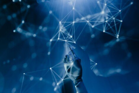 A robotic hand interacting with a digitally enhanced network of nodes and connections, all set against a blue background.