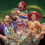 A group of six people dressed in colorful clown costumes, posing cheerfully against a green background with a golden swirl.
