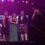 Group of people on stage at Scotland's Health Awards, two women holding a trophy. A photo of Lucy Flaws, NHS Shetland, "Leader of the Year" winner, is displayed on a screen.