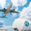 Airplane flying over an airport near a large hydrogen fuel tank marked with "H₂ Hydrogen" under a blue sky with clouds.