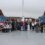 A large group of people pose for a photo on the deck of a ferry, with a “Shetland Youth Voice” banner visible on the left side of the image.