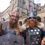 Two men dressed in Viking costumes with helmets and shields stand outside a historic stone building, with Scottish and UK flags in the background.