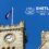 A stone clock tower with a flag on top against a blue sky. Text reads "Shetland Islands Council 1975-2025" with a crest.