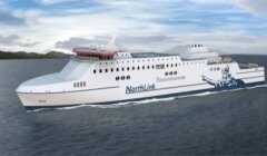 A large white NorthLink ferry with blue accents sails on calm water under a cloudy sky.