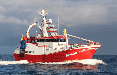 A red and white fishing vessel labeled "BF-800 RELIANCE III" travels through the ocean under a cloudy sky.