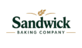 Logo for Sandwick Baking Company, with "Sandwick" in large dark green serif lettering, a golden wheat sheaf above, and "BAKING COMPANY" in